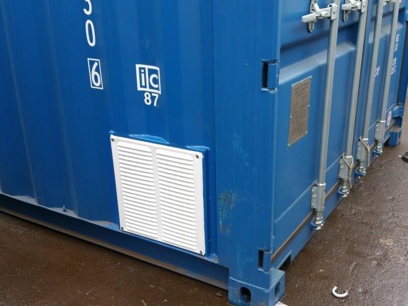 Louvered ventilation grilles fitted to a steel shipping container wall.