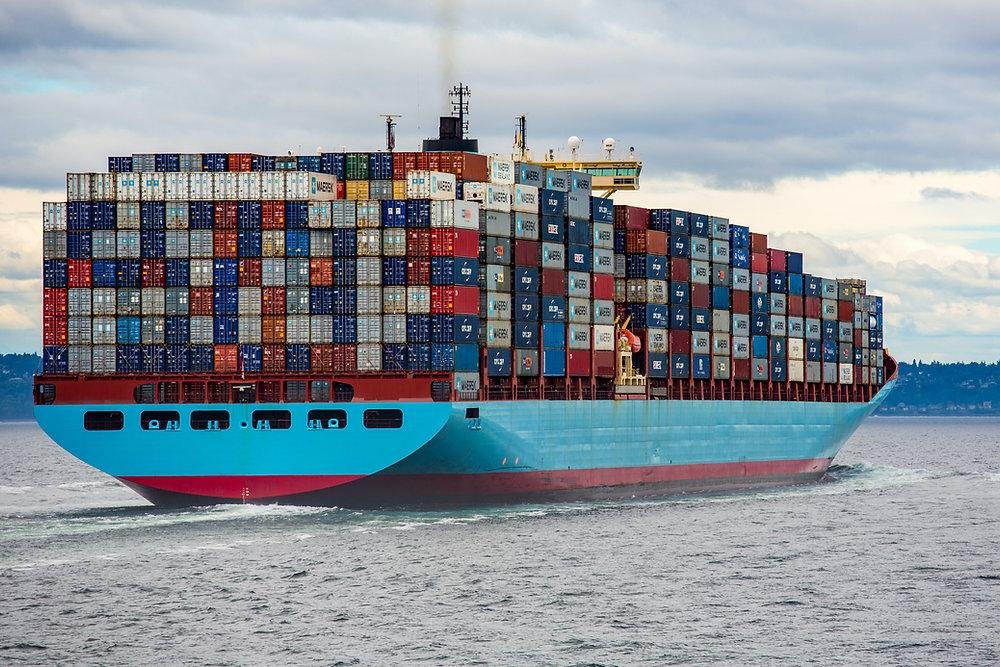 Shipping containers stacked and secured aboard a cargo ship.